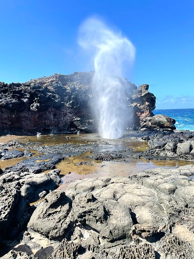  Nakalele blow hole showing ocean water spitting out of the hole from underneath